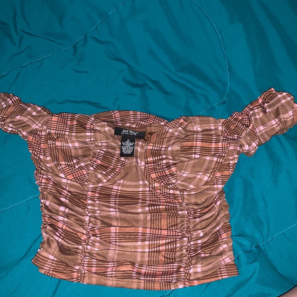 it’s a size medium. a cropped off the shoulder plad brown. brand just polly